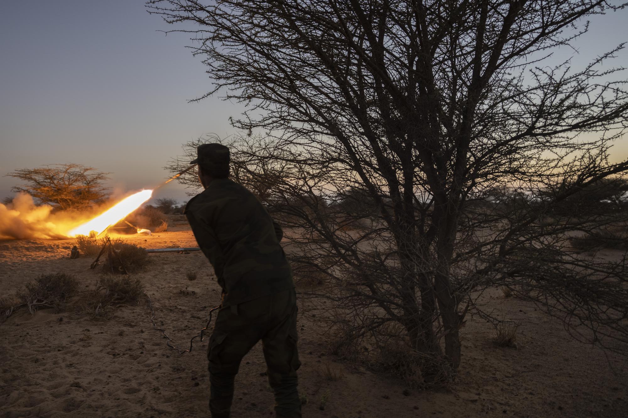 A soldier from the Polisario Front fires a rocket towards Morocco, near Mehaires, Western Sahara, Thursday, Oct. 14, 2021. After 30 years of ceasefire, the Polisario Front has taken up arms again in its quest for an independent Western Sahara. The flaring up of the conflict is fueled by frustration among new generations of Sahrawi refugees who believe that the wait for a referendum on self-determination, as promised by the United Nations, has only played on Morocco's benefit while their lives languished in the unforgiving desert camps. (AP Photo/Bernat Armangue)