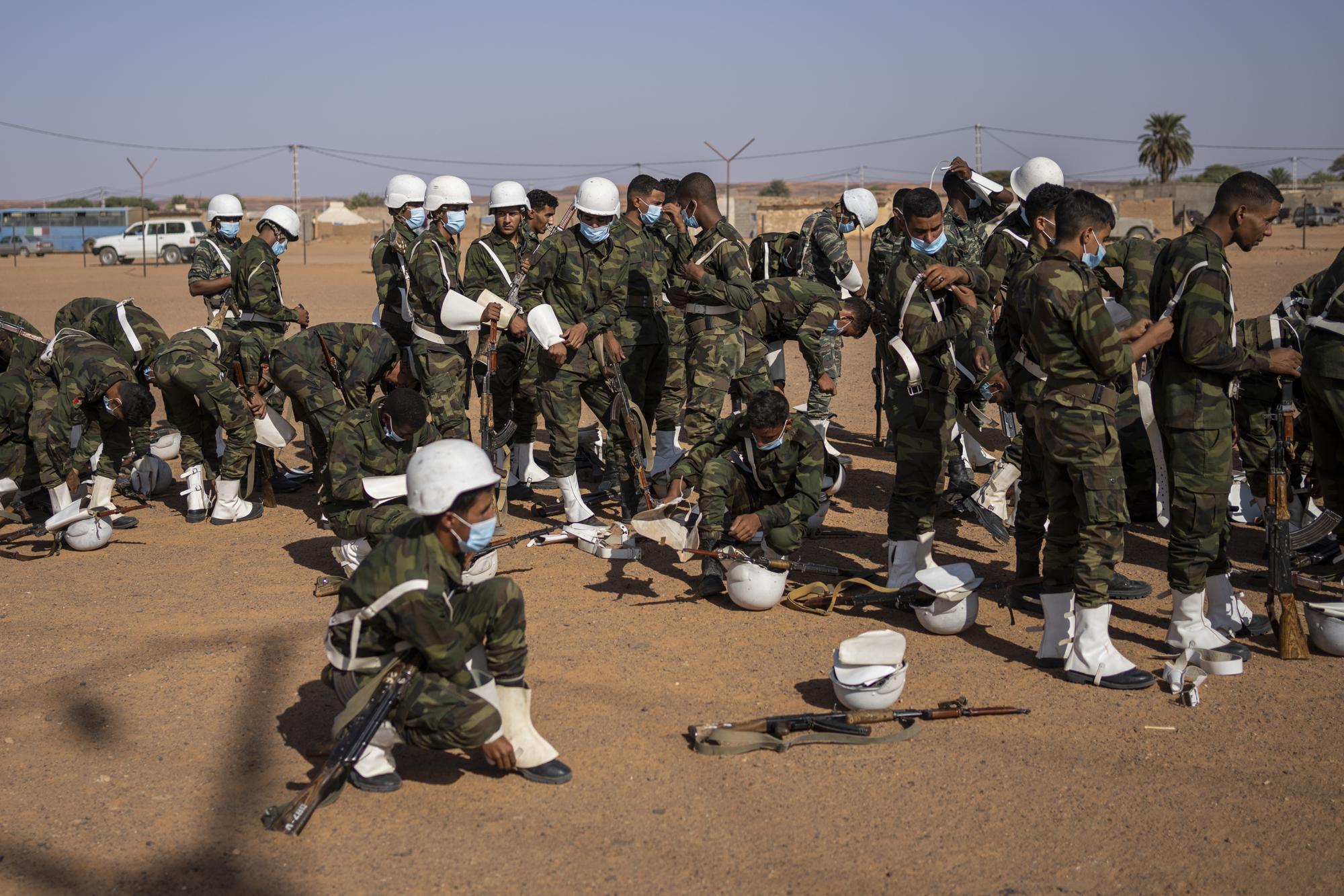 Soldiers from the Polisario Front pack after a National Unity Day event in the Dajla refugee camp, Algeria, Tuesday, Oct. 12, 2021. (AP Photo/Bernat Armangue)